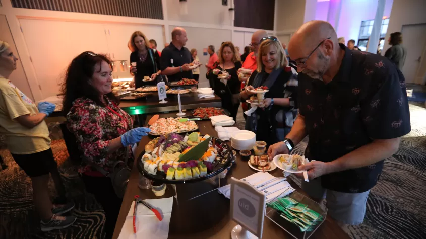 A guest is served an array of hors d'oeuvres during our opening night VIP event.