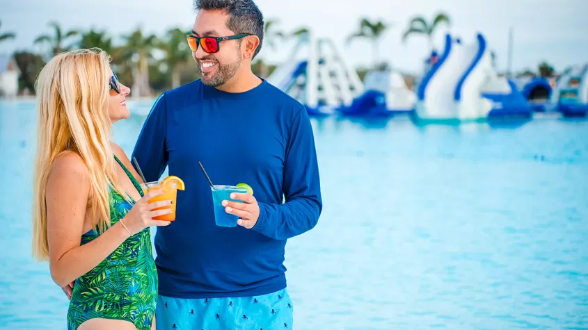 couple walking on beach at lagoon