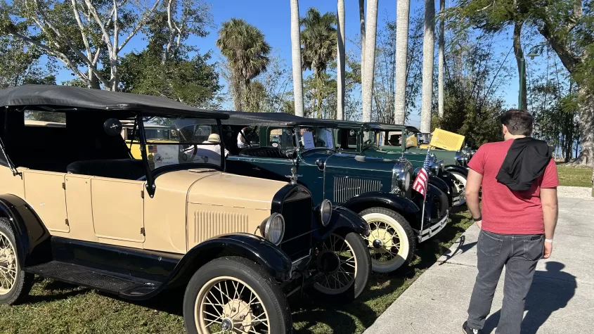 Visitors look at some of the Ford models of the decades at the car show. 