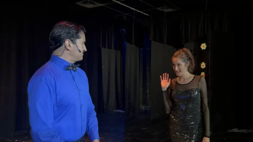 Two performers dancing together.