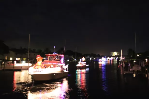 Decorated boats sail up a canal.
