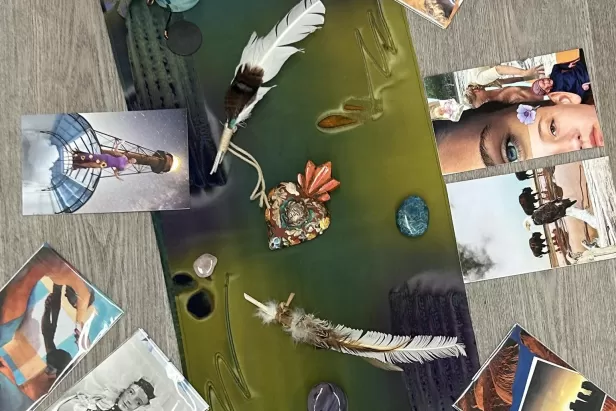 green mat on a wood floor with pictures from magazines around it
