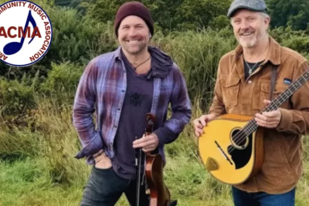 Two men standing, one with a mandolin and the other with a fiddle.  ACMA logo in corner.
