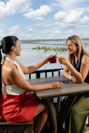 Women enjoying a drink at a rooftop bar