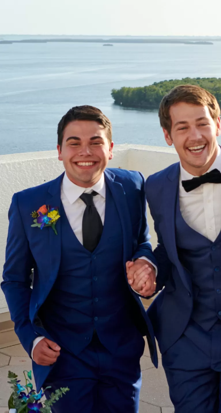 two men celebrate their wedding at a rooftop venue